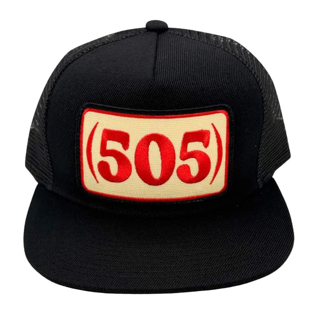 A black trucker hat with a beige rectangular patch on the front featuring the red text '(505)'.