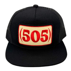 A black trucker hat with a beige rectangular patch on the front featuring the red text '(505)'.