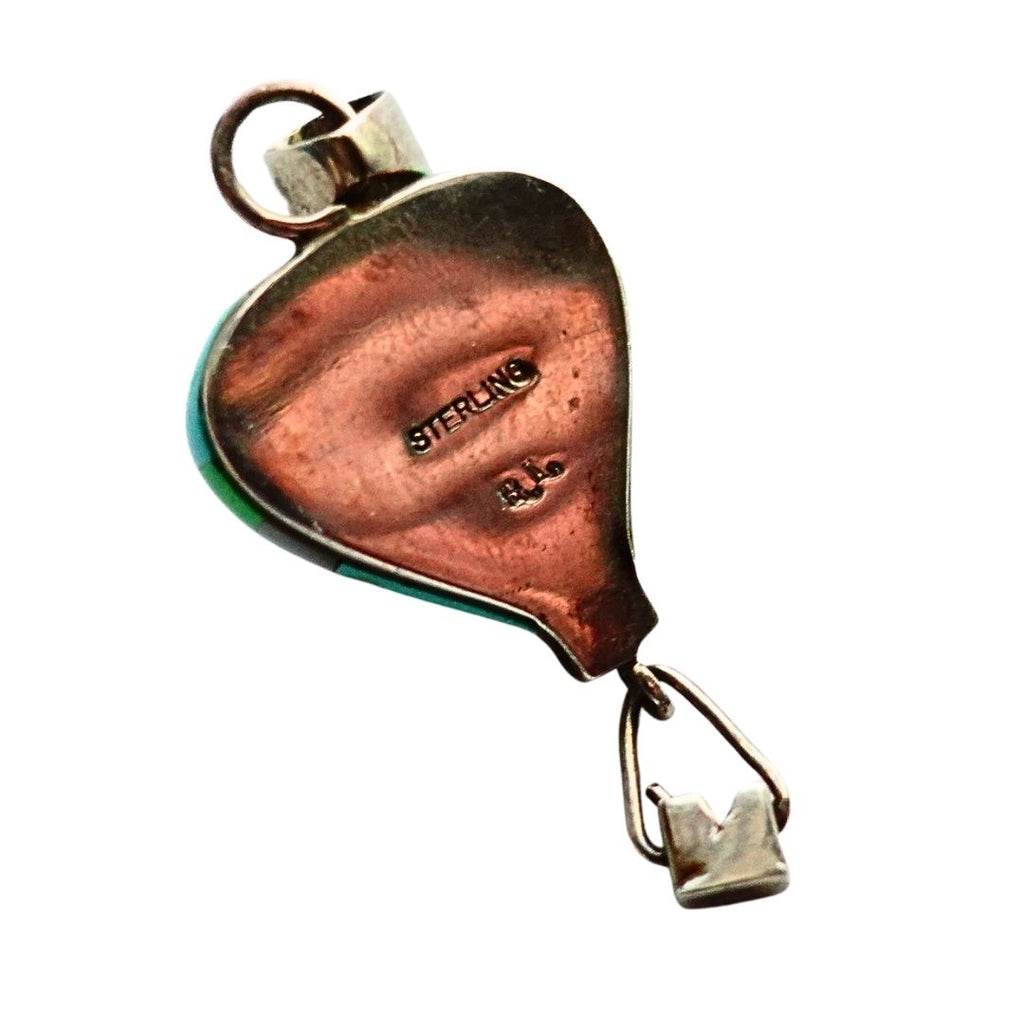 A sterling silver and balloon pendant with a small hanging bail, featuring a green inlay accent on the left side and 'STERLING 925' stamped on the back, shown against a plain white background.