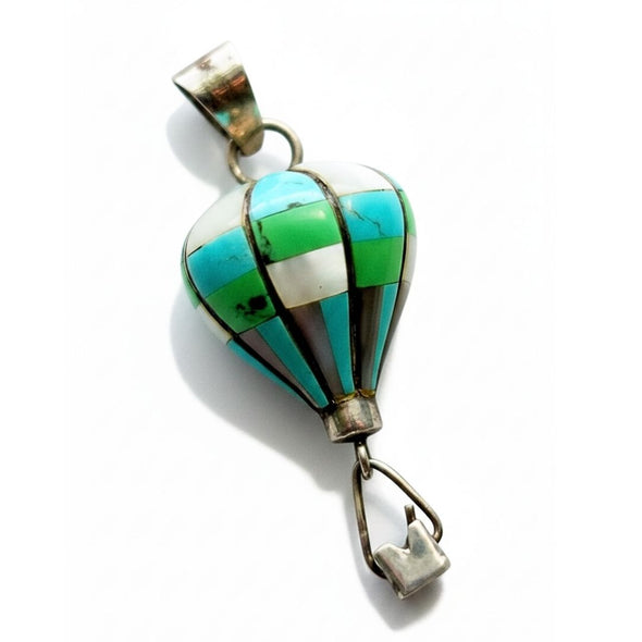A vintage silver hot air balloon pendant featuring inlay turquoise, green, white, and brown stones, shown on a plain white background.