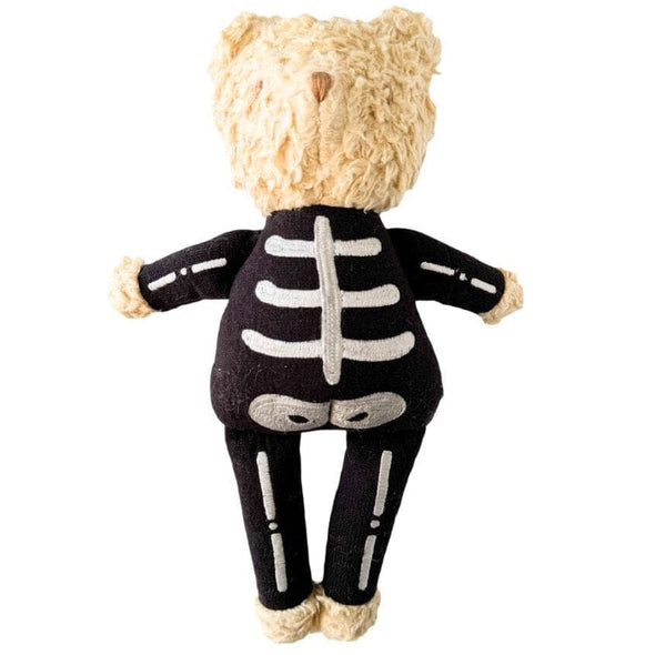 A plush teddy bear viewed from the back, wearing a black skeleton costume with white embroidered bones, on a plain white background.