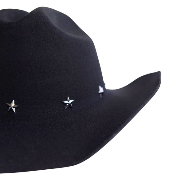 A close-up of a black cowboy hat featuring three small silver star-shaped studs on the side, set against a plain white background.