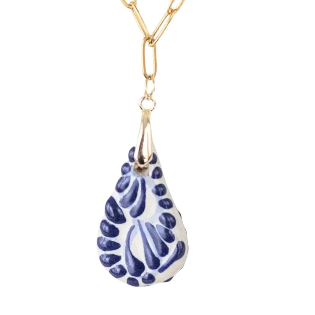 A gold-tone chain necklace featuring a teardrop-shaped Talavera ceramic pendant with a blue and white floral pattern, shown against a plain white background.