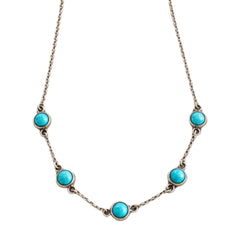 A silver-toned chain necklace featuring five evenly spaced round turquoise-blue cabochon stones, displayed against a solid white background.