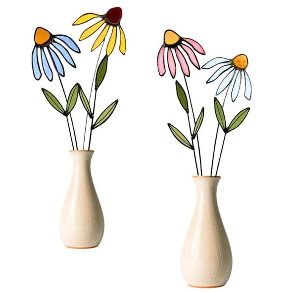 Two decorative ceramic vases with stained glass corn flowers, shown on a plain white background. The left vase has blue petals, a yellow center, and a dark red flower above it.