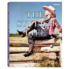 The Stylish Life Cowboys book cover featuring a vintage photograph of a cowgirl sitting on wooden logs under a blue sky.