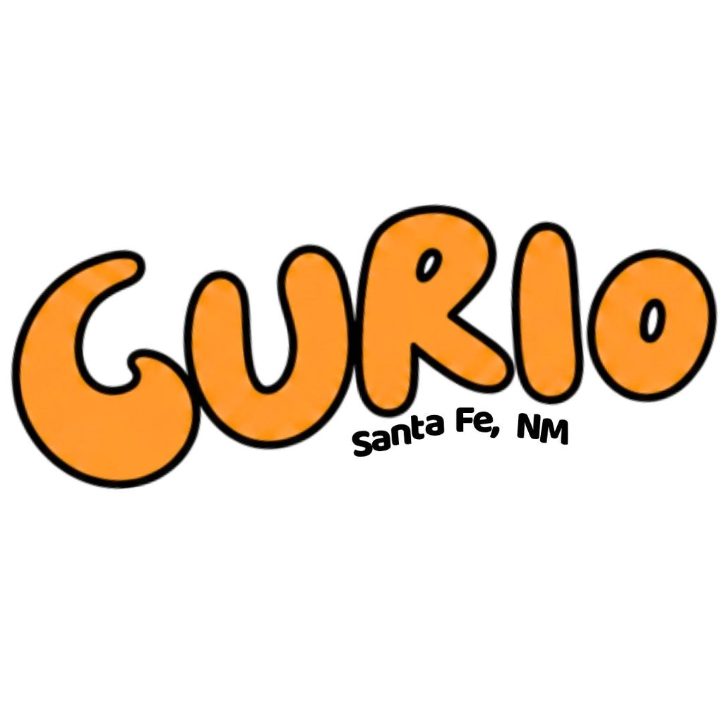 A graphic logo featuring the word 'CURIO' in bold orange bubble letters with black outlines, and smaller black text reading 'Santa Fe, NM' underneath, set against a plain white background.