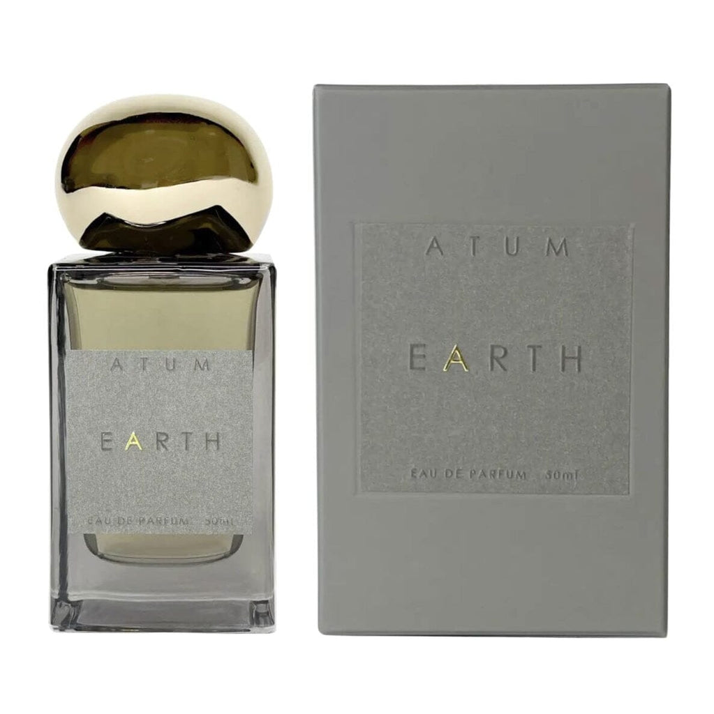 A bottle of EARTH Eau de Parfume fragrance with a reflective gold cap next to its textured gray packaging box on a white background.