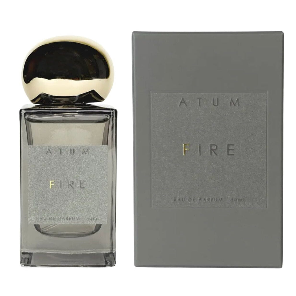 A 30ml bottle of FIRE Eau de Parfume fragrance next to its grey packaging box, featuring a reflective dark cap and a textured grey label with gold lettering.