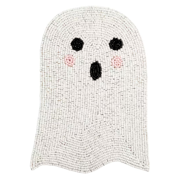 A ghost-shaped trivet made of white and light gray textured beads, featuring a simple black face with pink cheeks on a plain white background.
