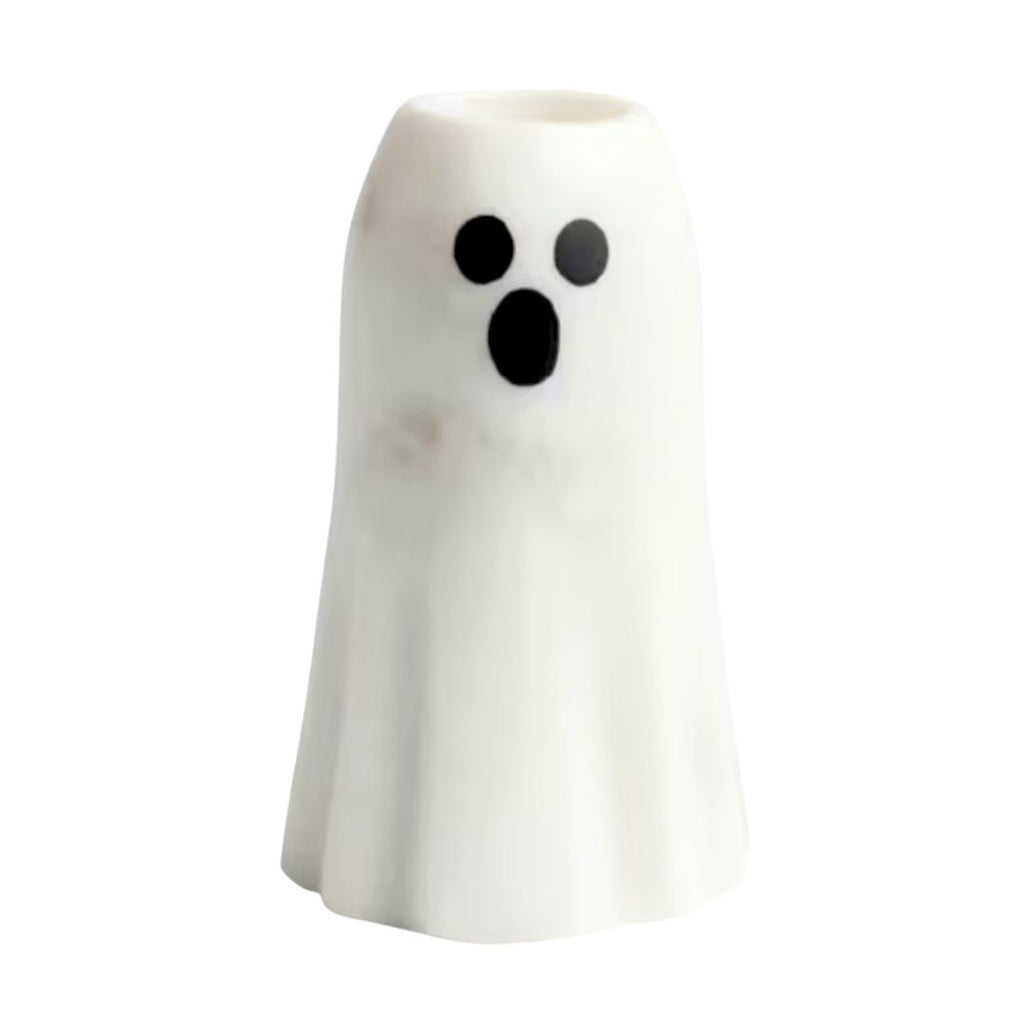 A small white ghost-shaped taper candle holder with a black surprised face, shown on a plain white background.