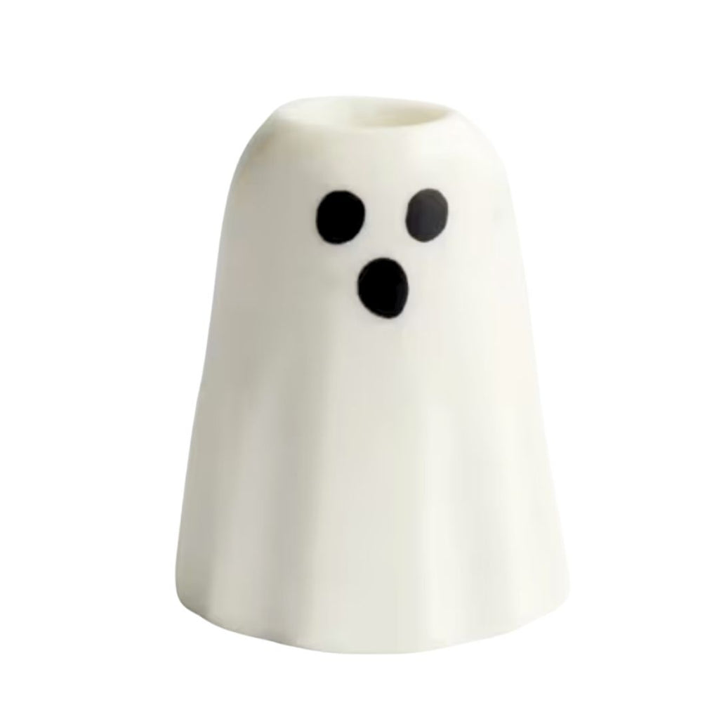 A small white ghost-shaped taper candle holder with a black surprised face, shown on a plain white background.