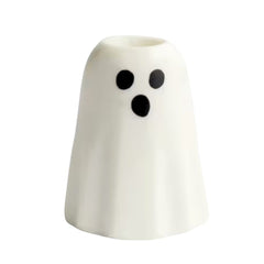 A small white ghost-shaped taper candle holder with a black surprised face, shown on a plain white background.