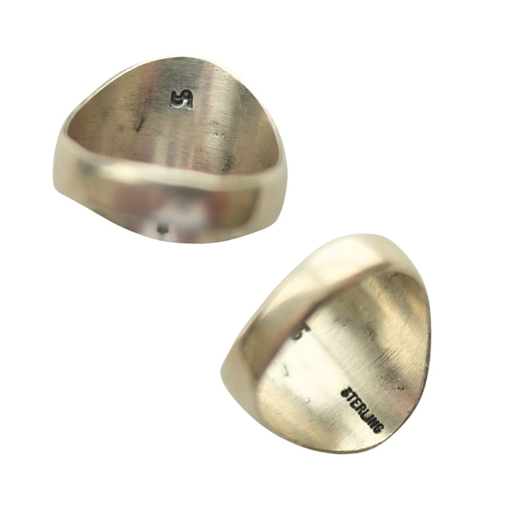 Two views of a sterling silver band ring with a wide, rounded triangular face, showing the brushed metal texture and 'STERLING' engraving on the inside.