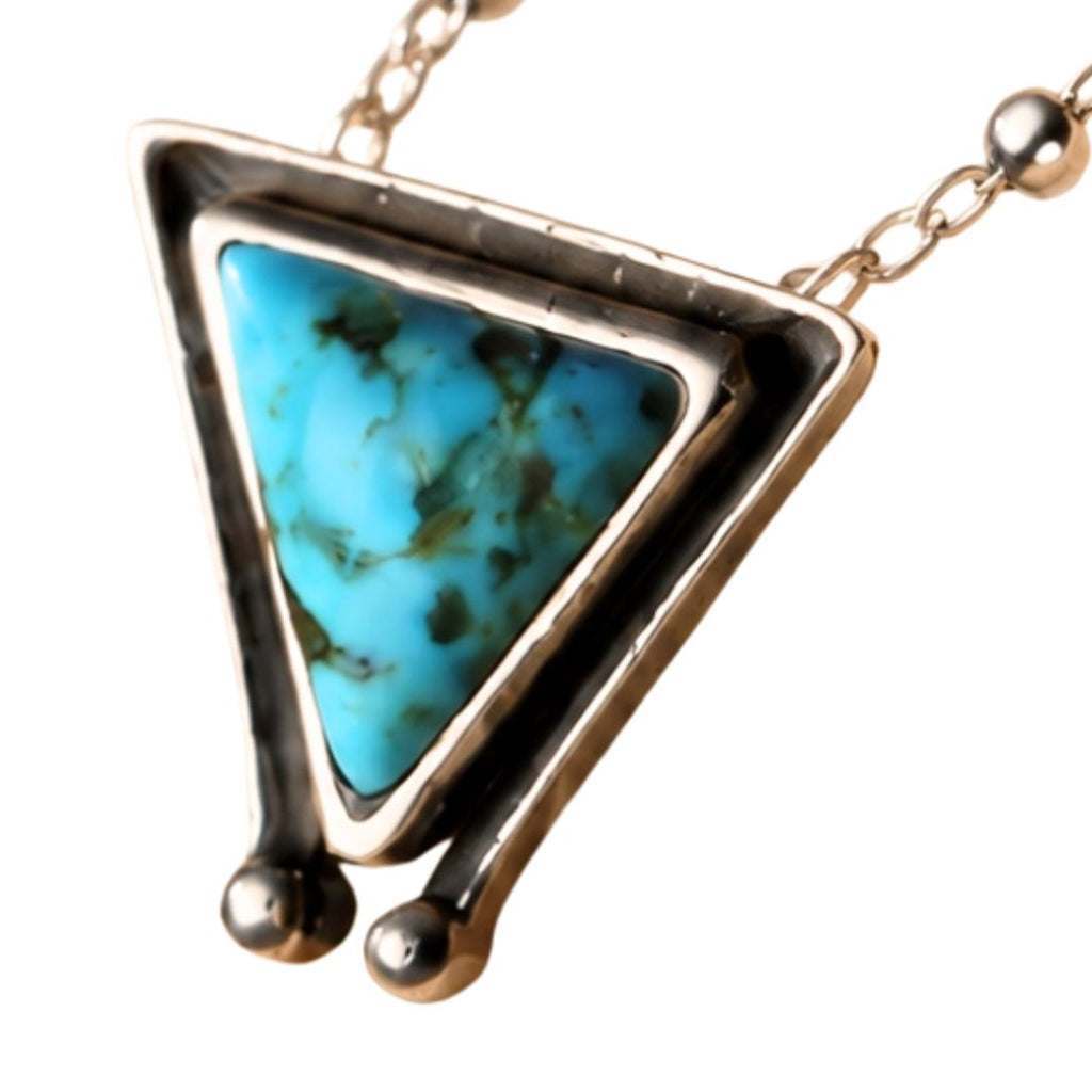 A triangular pendant necklace featuring a vibrant turquoise-blue marbled stone set in a textured silver-tone metal frame with a matching chain, shown against a plain white background.