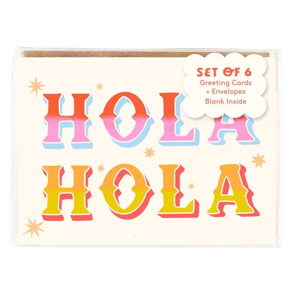 A set of 6 greeting cards and envelopes in clear plastic packaging, featuring a cream card front with the word 'HOLA' repeated in large pastel gradient letters and a white cloud label reading 'SET OF 6 Greeting Cards + Envelopes + Blank Inside'.