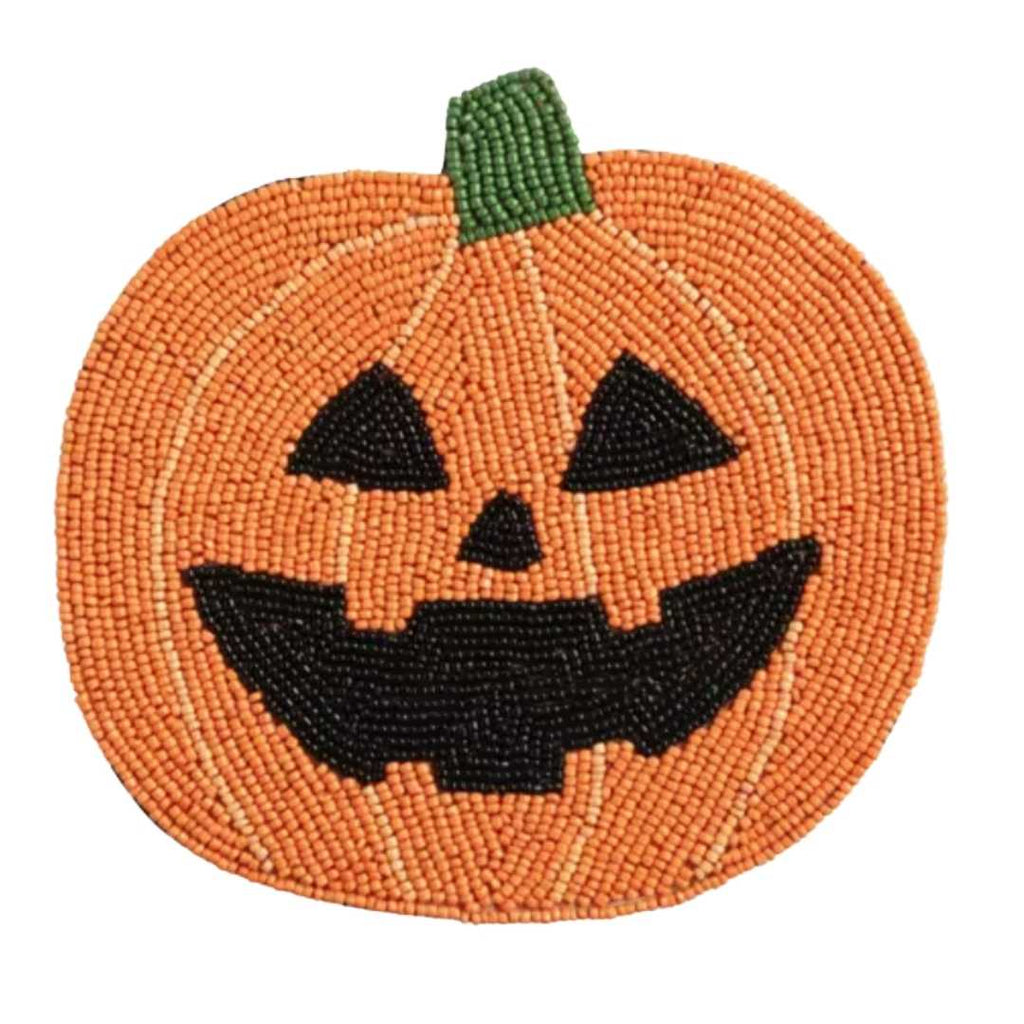A circular beaded pumpkin trivet featuring a carved jack-o'-lantern face, with an orange body, black facial features, and a green stem, shown on a plain white background.