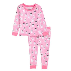 A two-piece children's pajama set in pink, featuring a long-sleeve top and matching pants with an all-over white ghost pattern and solid pink cuffs and hem.