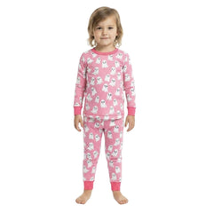 A young child wearing a pink long-sleeve pajama set with a white ghost pattern, standing against a plain white background.