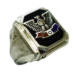 A silver-toned signet ring featuring a black enamel face with an eagle emblem and a small red, white, and blue banner, shown on a plain white background.