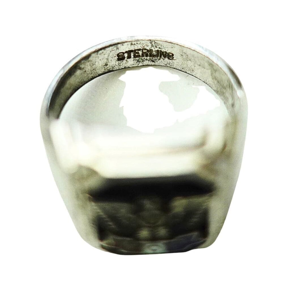 A sterling silver signet ring with a wide, polished band and a dark, engraved face, shown on a plain white background.