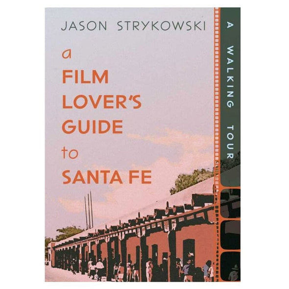 Book cover for 'A Film Lover's Guide to Santa Fe' by Jason Strykowski, featuring a retro-style illustration of a train station scene in muted pink, orange, and gray tones, with a dark vertical spine strip reading 'A Walking Tour.'.