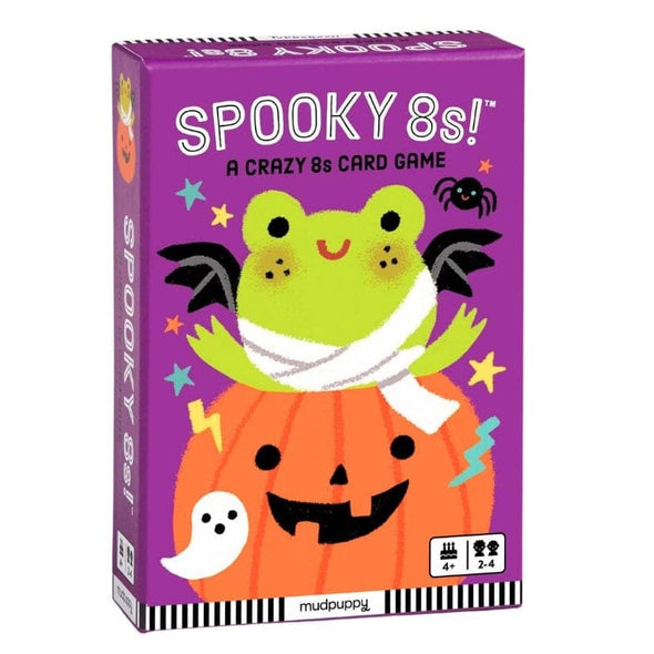 The product is a boxed card game titled 'Spooky 8s!' shown on a plain white background. The box is purple with a large green frog wearing black bat wings and a white bandage sitting on an orange jack-o'-lantern, plus small Halloween illustrations including stars, lightning, a ghost, and a spider.