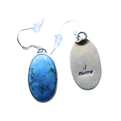 A pair of oval drop earrings featuring vibrant blue turquoise stones in silver bezel settings with silver fishhook ear wires, shown against a plain white background by Navajo Silversmith Jason Livingston