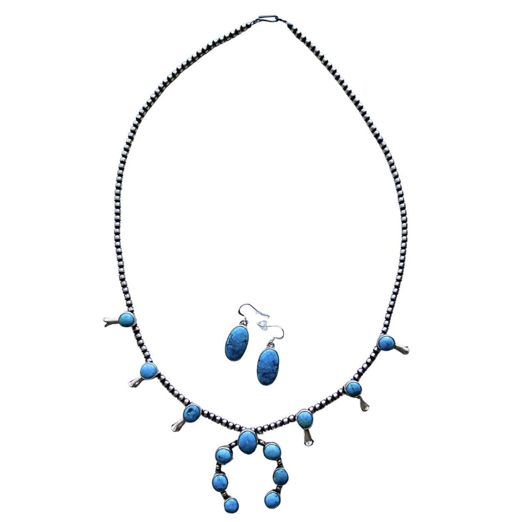 A turquoise and sterling silver Native American style necklace and matching dangle earrings on a plain white background by Navajo silversmith Jason Livingston