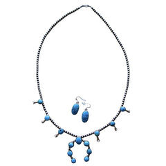 A turquoise and sterling silver Native American style necklace and matching dangle earrings on a plain white background by Navajo silversmith Jason Livingston