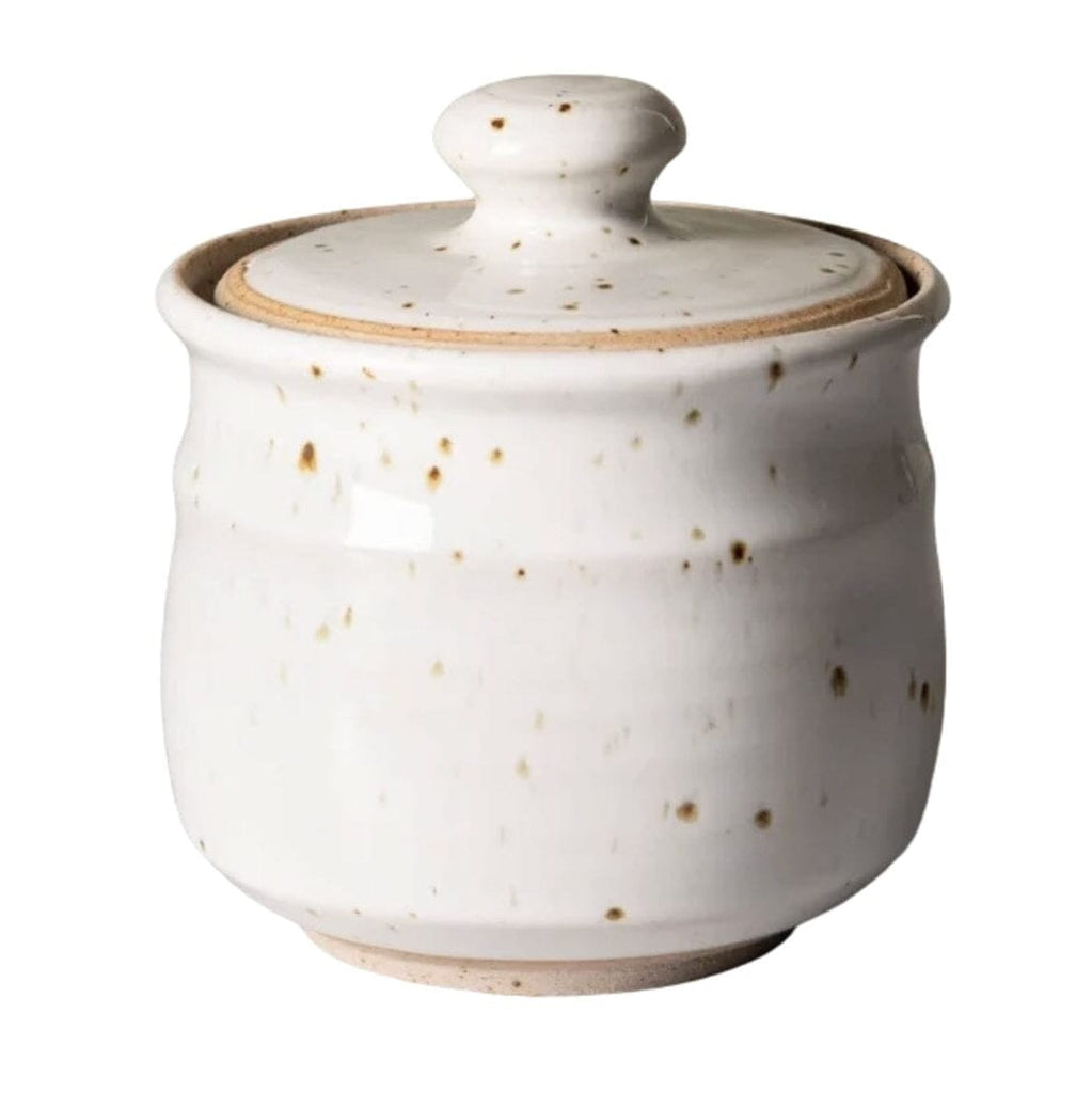 A small ceramic lidded Sugar jar with a rounded body, matching lid, and a speckled off-white glaze with scattered brown speckles, shown on a plain white background.