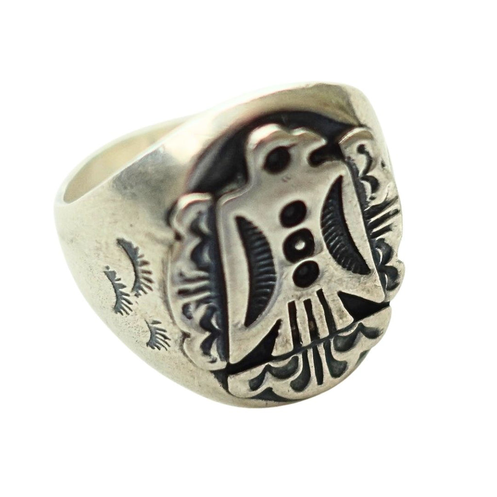 A silver-toned signet ring featuring a highly detailed, raised Thunderbird emblem with dark oxidized recesses, shown on a plain white background.