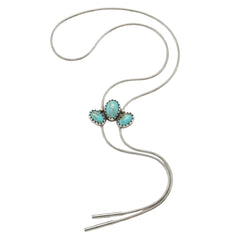 A silver lariat bolo tie necklace featuring three oval turquoise-colored stones in a cluster setting, displayed on a clean white background.