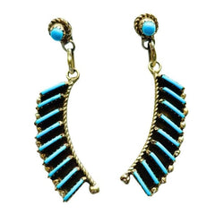 A pair of dangle earrings by Davis Kaamasee with curved rows of turquoise beads and a small round turquoise stone at the top, shown on a plain white background.