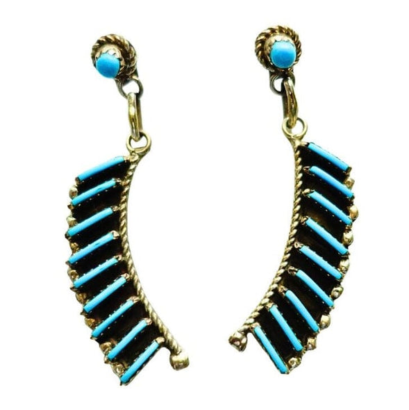 A pair of dangle earrings by Davis Kaamasee with curved rows of turquoise beads and a small round turquoise stone at the top, shown on a plain white background.