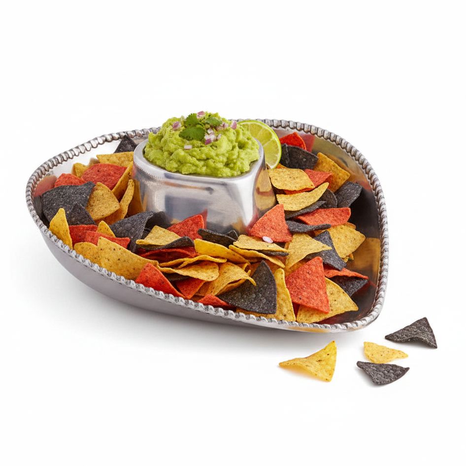Cowboy hat shaped silver serving tray filled with colorful tortilla chips and a guacamole with lime wedges, 