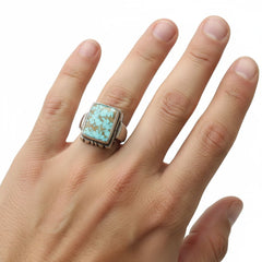 Vintage sterling silver square signet ring with rare blue water web birdseye turquoise stone on male hand